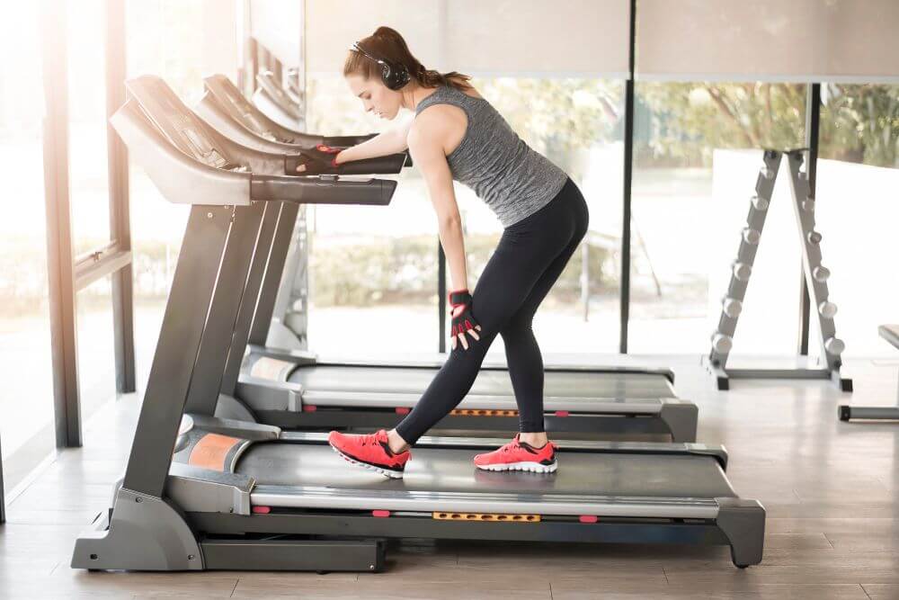 Woman addressing pain on the Best Low-Impact Treadmill