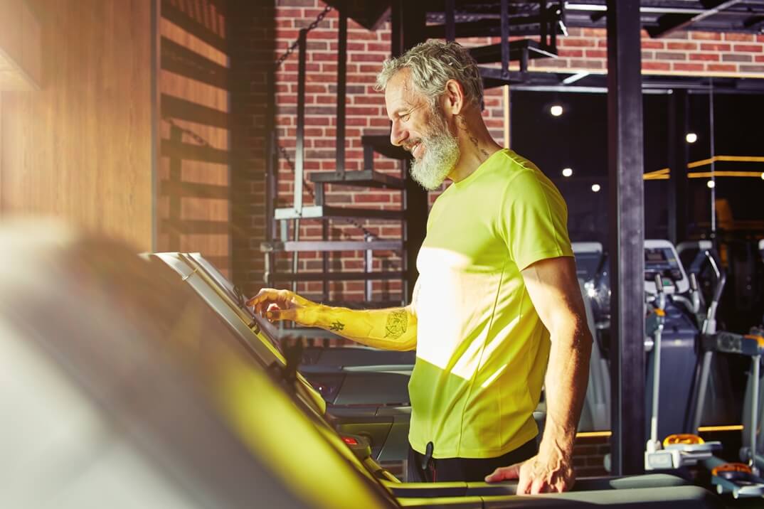 An Older Male Happily Working Out on a Treadmill for Garage