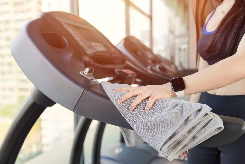 A lady learning How To Maintain A Treadmill