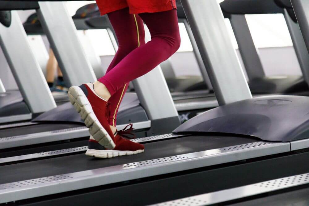 A woman running on a Treadmill wearing comfortable shoes