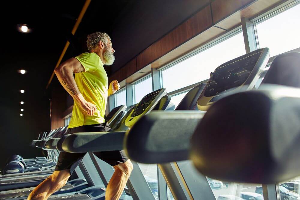 An old man running on a treadmill